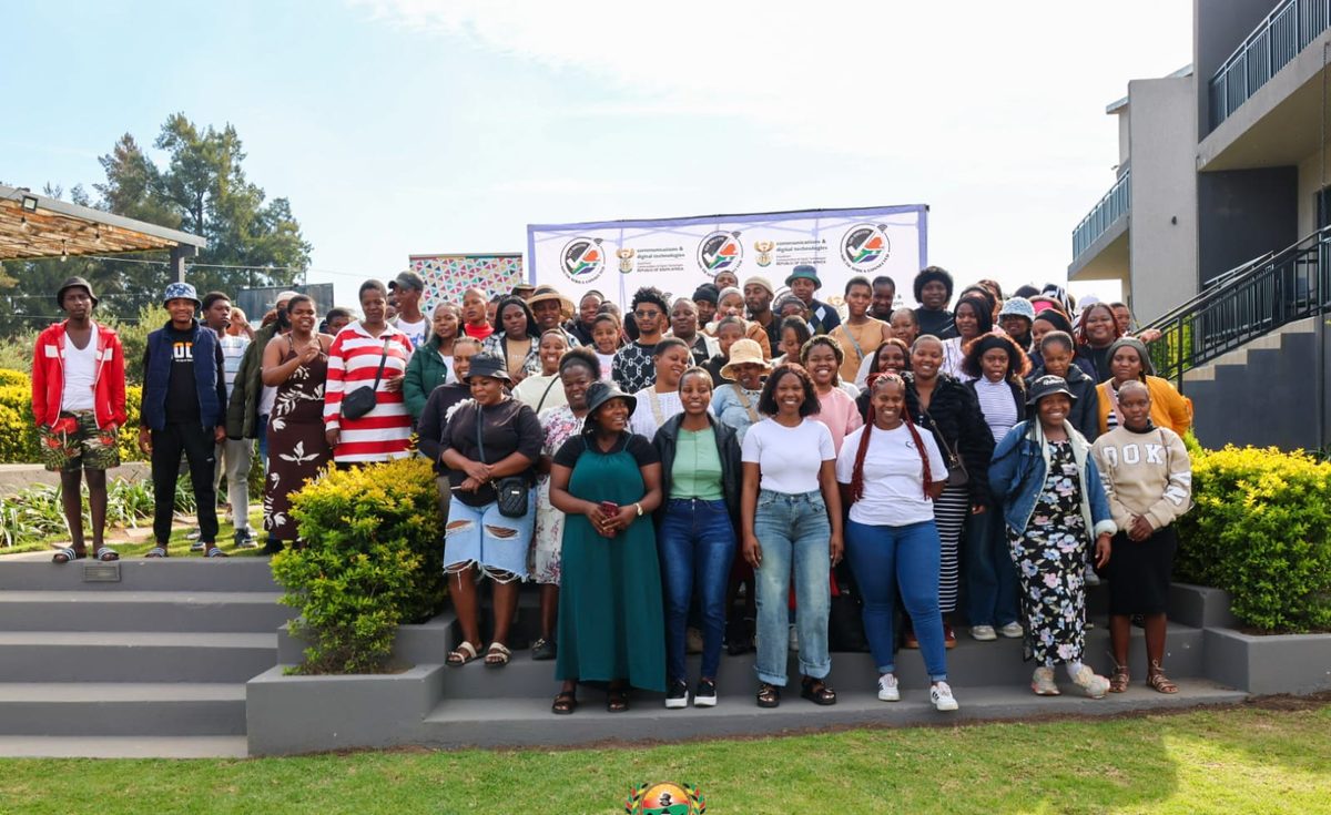 A cohort of learners photographed together outside at a NIBS event.